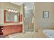This bathroom features a large shower, granite counters, and decorative mirrors at 310 Westbourne Dr, Tyrone, GA 30290