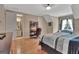 Bedroom view with hardwood floors, a sitting area, and doorway to an ensuite bathroom with vanity at 310 Westbourne Dr, Tyrone, GA 30290