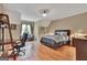 Bedroom boasts hardwood floors, a sitting area, and a workspace with a desk and office chair at 310 Westbourne Dr, Tyrone, GA 30290