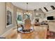 Cozy dining area featuring a chandelier, hardwood floors, and views of the backyard at 310 Westbourne Dr, Tyrone, GA 30290