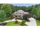 Beautiful brick two-story home with lush landscaping and a circular driveway at 310 Westbourne Dr, Tyrone, GA 30290