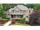Lovely two-story brick home with manicured landscaping and a covered front porch at 310 Westbourne Dr, Tyrone, GA 30290