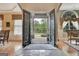 Foyer with slate entry, iron doors, and view to the front yard with decorative pillars and manicured landscaping at 310 Westbourne Dr, Tyrone, GA 30290