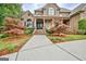 Stunning brick home with lush landscaping and a sidewalk leading to the front door at 310 Westbourne Dr, Tyrone, GA 30290