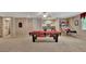 Basement game room with a pool table, basketball game, and built-in bar area at 310 Westbourne Dr, Tyrone, GA 30290