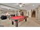 Large game room with a pool table, seating, and stairs to another level at 310 Westbourne Dr, Tyrone, GA 30290