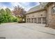 Spacious three-car garage exterior featuring brick facade, a large driveway, and mature landscaping at 310 Westbourne Dr, Tyrone, GA 30290