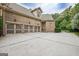 Three car garage and extra parking space with brick exterior and side entry door at 310 Westbourne Dr, Tyrone, GA 30290