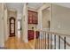 Elegant hallway featuring hardwood floors, staircase, and custom built-in cabinetry at 310 Westbourne Dr, Tyrone, GA 30290