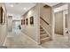 Hallway featuring neutral carpet and paint, as well as a stairway at 310 Westbourne Dr, Tyrone, GA 30290