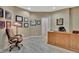 Well-lit home office with wood desk, neutral walls, and stylish, modern flooring throughout at 310 Westbourne Dr, Tyrone, GA 30290