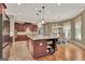 Open concept kitchen boasts a center island with bar stool seating and designer lighting fixtures at 310 Westbourne Dr, Tyrone, GA 30290