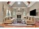 Spacious living room with vaulted ceilings, exposed beams, fireplace, and large windows at 310 Westbourne Dr, Tyrone, GA 30290