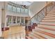 Large living room with a fireplace, view to the upstairs and many windows at 310 Westbourne Dr, Tyrone, GA 30290
