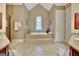 The main bathroom offers a large soaking tub and decorative tile at 310 Westbourne Dr, Tyrone, GA 30290
