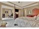 Spacious main bedroom featuring tray ceilings, wood furniture, and a sitting area at 310 Westbourne Dr, Tyrone, GA 30290