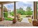 Spacious covered front porch with brick flooring, elegant columns, and a well-manicured front yard at 310 Westbourne Dr, Tyrone, GA 30290