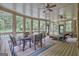 Relaxing screened porch with ceiling fans, poolside view, and comfortable seating for outdoor entertainment at 310 Westbourne Dr, Tyrone, GA 30290