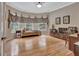 Bright sitting room features hardwood floors, a daybed, and three large windows with natural light at 310 Westbourne Dr, Tyrone, GA 30290