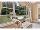 An elegant chaise lounge sits in front of a large window with pool views at 310 Westbourne Dr, Tyrone, GA 30290
