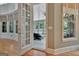 Sunroom doorway with paneled glass, flowing into the main room with hardwood flooring and natural lighting at 310 Westbourne Dr, Tyrone, GA 30290