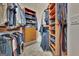 A spacious walk-in closet with custom shelving for clothes and shoes at 310 Westbourne Dr, Tyrone, GA 30290