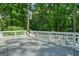 Large deck showcasing outdoor seating area with views of mature trees at 7025 Stone Wood Nw Dr, Kennesaw, GA 30152