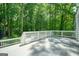 Spacious back deck surrounded by lush greenery, perfect for outdoor seating at 7025 Stone Wood Nw Dr, Kennesaw, GA 30152