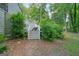 Landscaped backyard with stairs leading to upper deck and surrounding trees at 7025 Stone Wood Nw Dr, Kennesaw, GA 30152