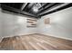 Finished basement space showing the open ceiling and floating wooden shelves at 7025 Stone Wood Nw Dr, Kennesaw, GA 30152