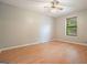 Bedroom featuring hard wood floors, window, and ceiling fan at 7025 Stone Wood Nw Dr, Kennesaw, GA 30152