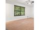 Bedroom featuring laminated wood floors, and a large window at 7025 Stone Wood Nw Dr, Kennesaw, GA 30152