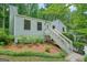 Beautiful home with lovely landscaping on the front hillside at 7025 Stone Wood Nw Dr, Kennesaw, GA 30152