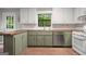 Charming kitchen featuring green cabinetry, wooden countertops, and stainless steel appliances at 7025 Stone Wood Nw Dr, Kennesaw, GA 30152