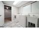 Functional laundry room equipped with a washer, dryer, and utility sink at 7025 Stone Wood Nw Dr, Kennesaw, GA 30152