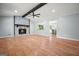 Light-filled living room featuring a cozy stone fireplace, hardwood floors, and beam at 7025 Stone Wood Nw Dr, Kennesaw, GA 30152