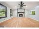 Spacious living room with hardwood floors, fireplace, and modern ceiling fan at 7025 Stone Wood Nw Dr, Kennesaw, GA 30152