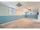 The basement features a ceiling fan and three windows that brighten the large room at 113 Hitchcock Dr, Villa Rica, GA 30180