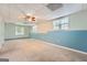 The basement features a ceiling fan and two windows that brighten the large room at 113 Hitchcock Dr, Villa Rica, GA 30180