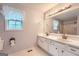Bathroom featuring double sinks, a large mirror with decorative lighting, and a shower-tub combination at 113 Hitchcock Dr, Villa Rica, GA 30180