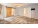 Large carpeted bedroom featuring a ceiling fan, barn door, and access to other rooms in the house at 113 Hitchcock Dr, Villa Rica, GA 30180