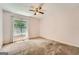 This bedroom has a ceiling fan and window overlooking a tree-filled backyard at 113 Hitchcock Dr, Villa Rica, GA 30180