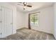This bedroom features a ceiling fan and a window overlooking a tree-filled front yard at 113 Hitchcock Dr, Villa Rica, GA 30180