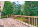 Wooden deck overlooking the tree-filled backyard creates a serene setting to enjoy the outdoors at 113 Hitchcock Dr, Villa Rica, GA 30180