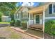 A charming home featuring a covered front porch with white railings and well-maintained landscaping at 113 Hitchcock Dr, Villa Rica, GA 30180