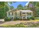 Charming single-Gathering home with muted green siding, dark shutters, and a well-manicured front lawn at 113 Hitchcock Dr, Villa Rica, GA 30180