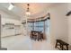 Eat-in kitchen featuring white cabinets, light vinyl floors, and a cozy dining area with large windows at 113 Hitchcock Dr, Villa Rica, GA 30180