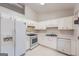 Bright kitchen features white appliances and cabinets, offering a clean and functional cooking space at 113 Hitchcock Dr, Villa Rica, GA 30180
