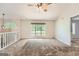 Spacious living room with plush carpet, a large window overlooking the outdoors, and a modern ceiling fan at 113 Hitchcock Dr, Villa Rica, GA 30180