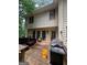 A weathered wood porch with outdoor furniture, grill, and multiple windows on the home at 974 Bloomfield Dr, Lawrenceville, GA 30044